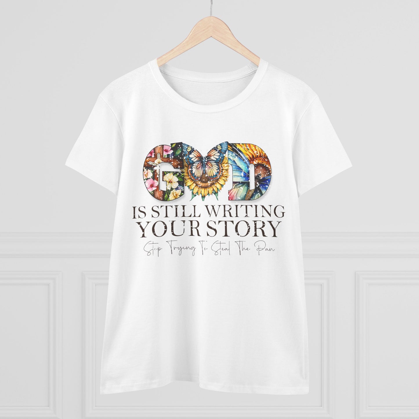 White t-shirt with colorful design and text on a wooden hanger against a white background